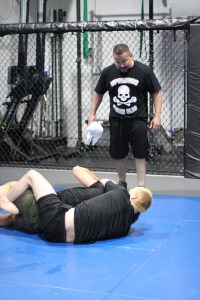 A coach observing a grappling session at Uprising MMA